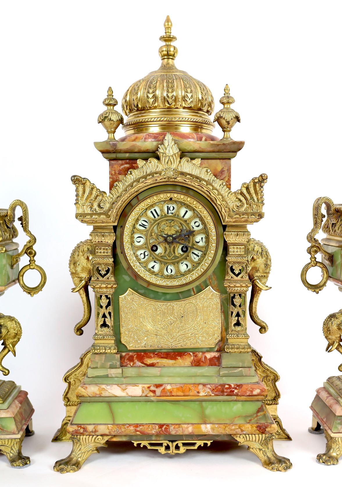 A late 19th century French ormolu mounted marble and green onyx clock garniture, of Indian inspiration, clock 34cm wide, 63cm high, side vases 36cm high